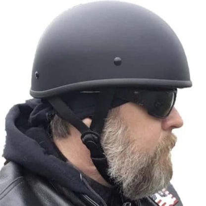 Person wearing a black helmet and sunglasses with a neutral background