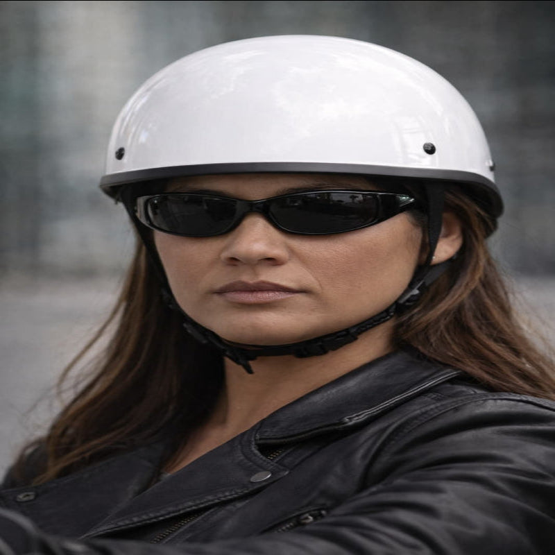Person wearing a white helmet and black sunglasses with a blurred background