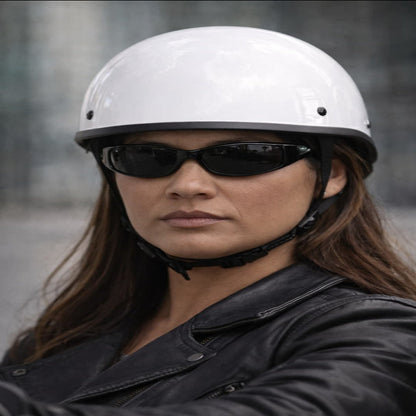 Person wearing a white helmet and black sunglasses with a blurred background
