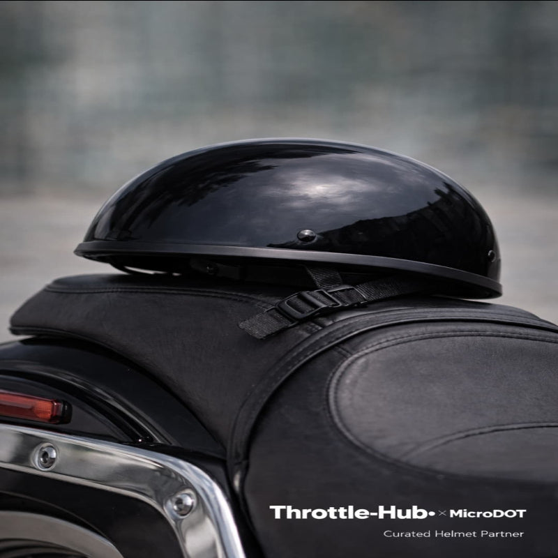 Person wearing a black helmet sitting on a motorcycle with 'Throttle-Hub' branding.