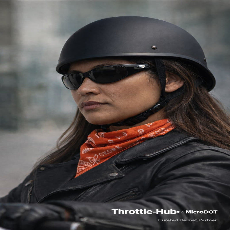 Person wearing a black helmet and sunglasses with a blurred background